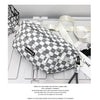 A plaid checkered crossbody chest bag in gray and white fabric with a light beige strap.