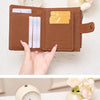A brown leather RFID-blocking compact bifold wallet shown in an angle display with a gold accent.
