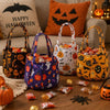 A collection of Halloween non-woven tote bags featuring ghost, bat, and skull designs displayed on a wooden surface.