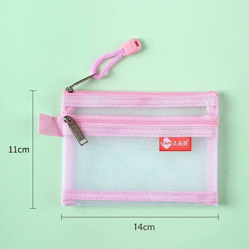 A pink double-layer zipper pouch with a clear window and a pink strap, shown against a light green background.