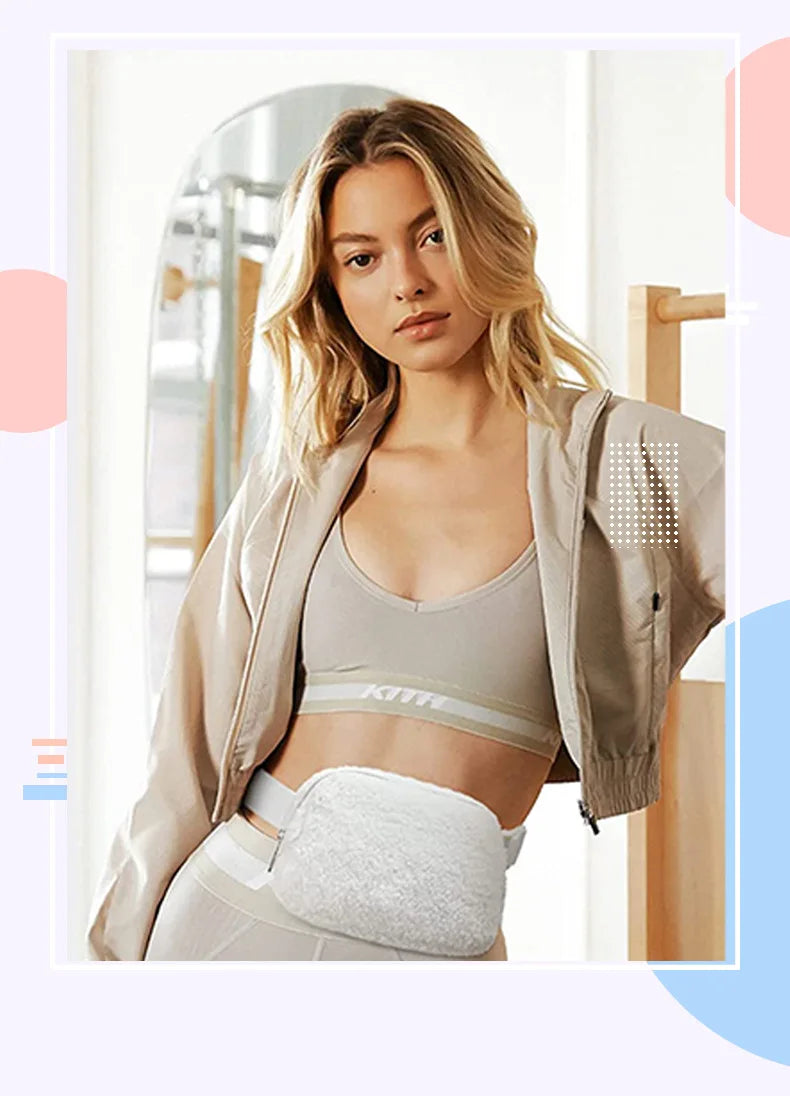 A woman models an ivory fleece crossbody belt bag worn over a sports bra and light-colored athletic wear.