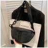 Black PU leather crossbody saddle bag with a chain strap displayed on a white box.