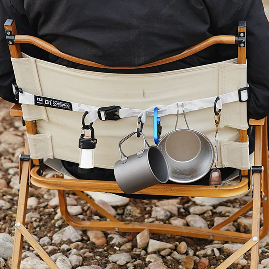 A beige durable outdoor camping crossbody strap is shown mounted on a wooden folding chair.