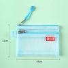 Light blue fabric pouch with a zipper and attached tag, shown against a green background.