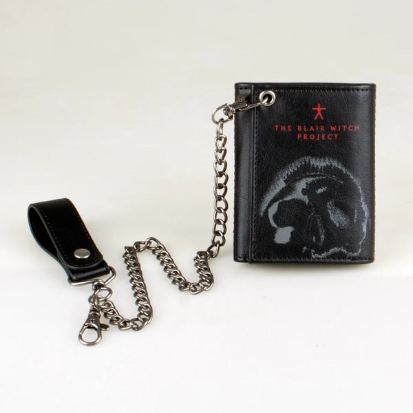 Black leather card holder wallet with a silver chain and a silhouette of a witch's head embossed on the cover