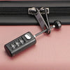 A black resettable 3-digit combination padlock with a silver shackle is shown against a pink background.