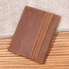 A brown genuine leather bifold card holder resting on a wooden surface.