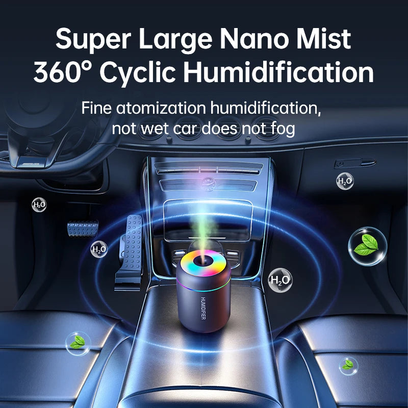 A mini USB electric aroma diffuser is shown in a car interior, emitting a fine mist for humidification.