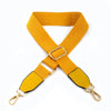 A bright yellow canvas cotton bag strap with metal hooks, shown in an 'X' shape.