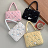 Tres bolsas de laptop acolchadas en rosa, negro y beige con detalles de lazo azul, mostradas sobre una superficie clara.