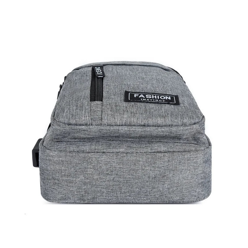A gray water-resistant casual chest bag with a black zipper and a fashion instinct logo.