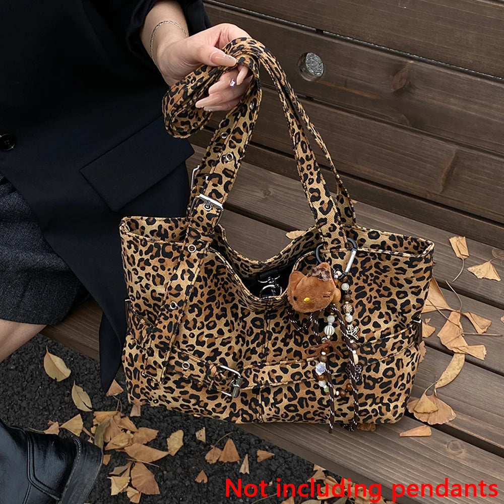 A leopard print casual tote bag is shown resting on a wooden surface next to a person's hand.