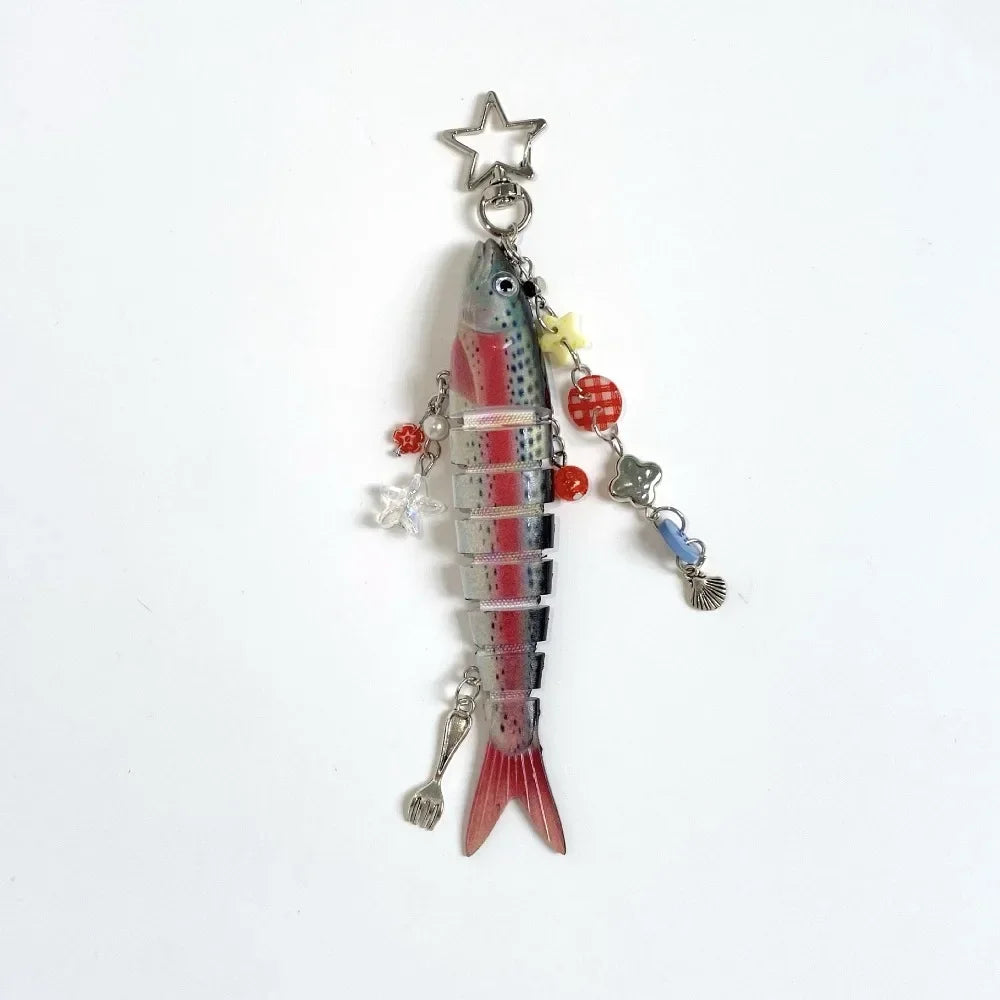 A silver simulation fish keychain featuring a red and white striped body and a star charm.
