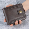A dark brown leather card wallet with a horizontal zipper and brass accent is held in a hand.