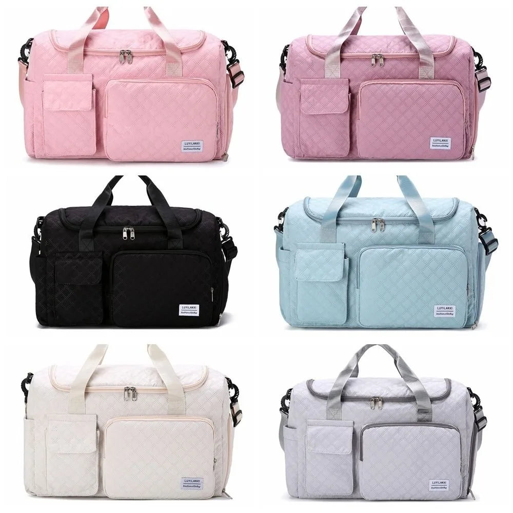 A set of five portable quilted travel duffle bags in pink, black, light blue, and cream colors.