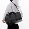 A person wearing a white hooded jacket is holding a black leather-trimmed travel duffle bag.