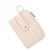 A light pink quilted PU leather card holder wallet with a gold bangle and tassel.