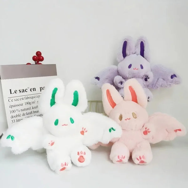 A collection of soft stuffed bunny plush toys in white and purple colors.