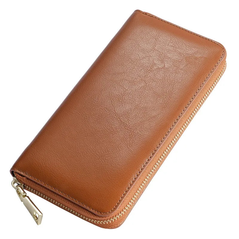 A brown genuine leather zipper wallet shown from above.