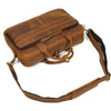 A brown vintage genuine leather briefcase with a flap and leather strap is shown.
