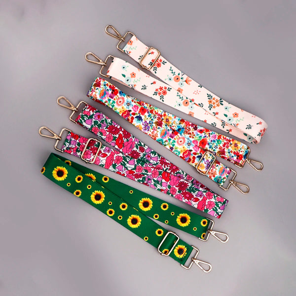 A collection of colorful floral pattern adjustable crossbody bag straps in various prints.