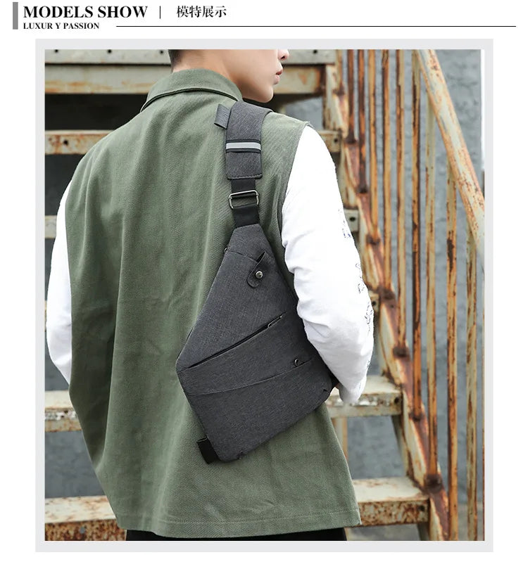 A man wearing a olive green shirt and a dark gray anti-theft crossbody chest bag on his back.
