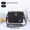 Black insulated portable lunch bag with a gray shoulder strap shown on a white surface.