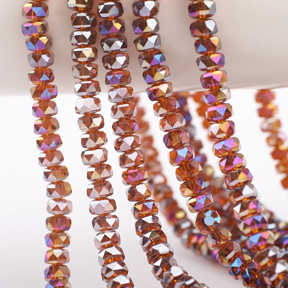 Strands of faceted crystal glass beads in various shades of amber and purple for jewelry making