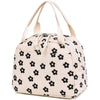 A beige corduroy lunch bag for kids with light yellow stitching and fabric flowers.