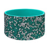 A teal silicone boot sleeve for water bottles with a sparkling silver and pink pattern.
