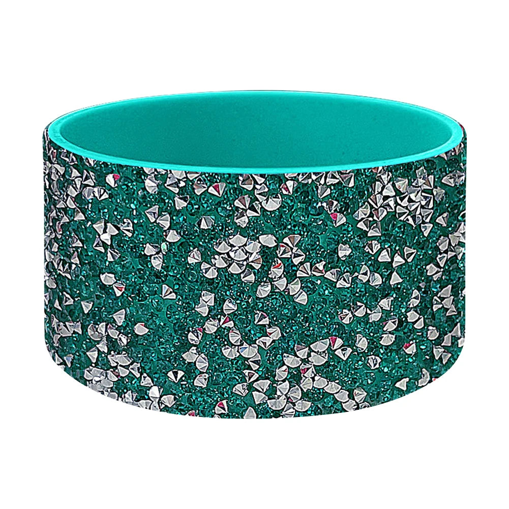 A teal silicone boot sleeve for water bottles with a sparkling silver and pink pattern.