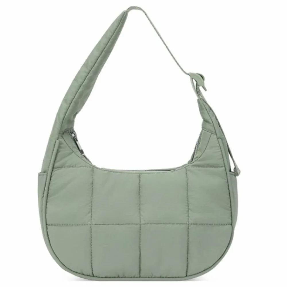 A light sage green quilted nylon shoulder bag with an adjustable strap.