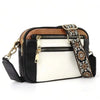 A black and white PU leather crossbody bag with gold hardware and a patterned strap.