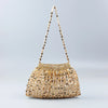 A handmade dumpling bag covered in gold and silver beads, displayed against a light gray background.