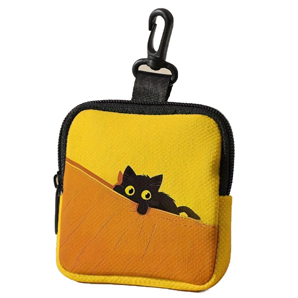 A yellow coin purse with a black strap and a silhouette of a black cat on an orange background.