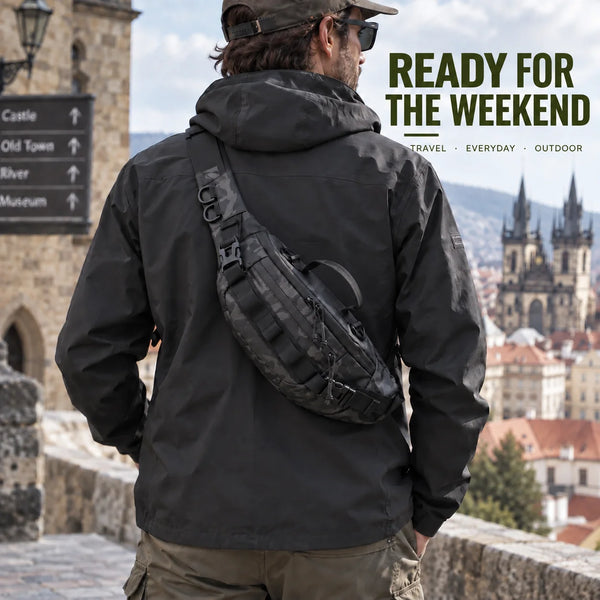 A person wearing a black tactical sling waist pack stands on a stone wall overlooking a historic city view.