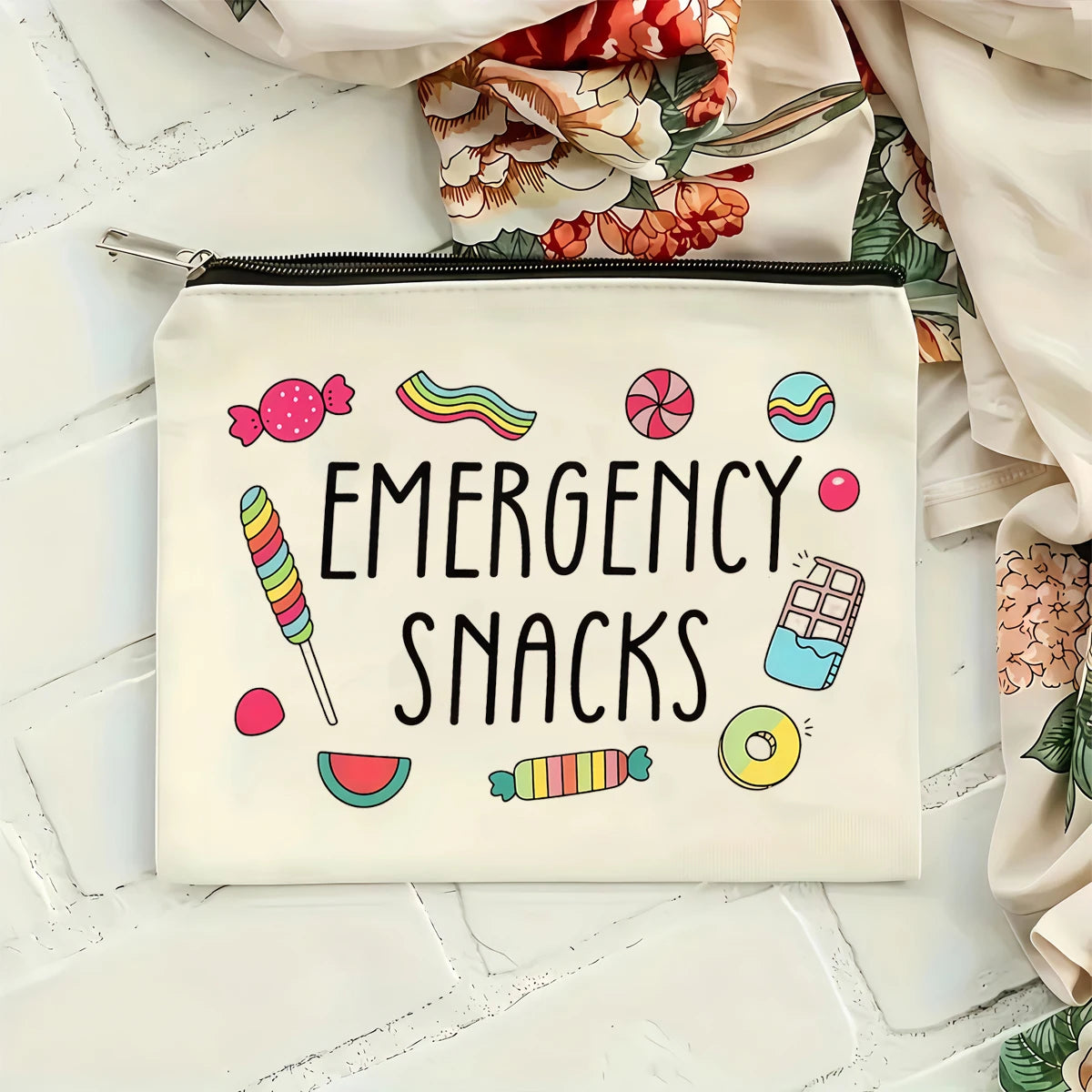 A cream-colored zippered pouch with black text reading Emergency Snacks and colorful illustrations of various snacks.