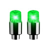 A pair of bright green LED tire valve stem lights for vehicles.