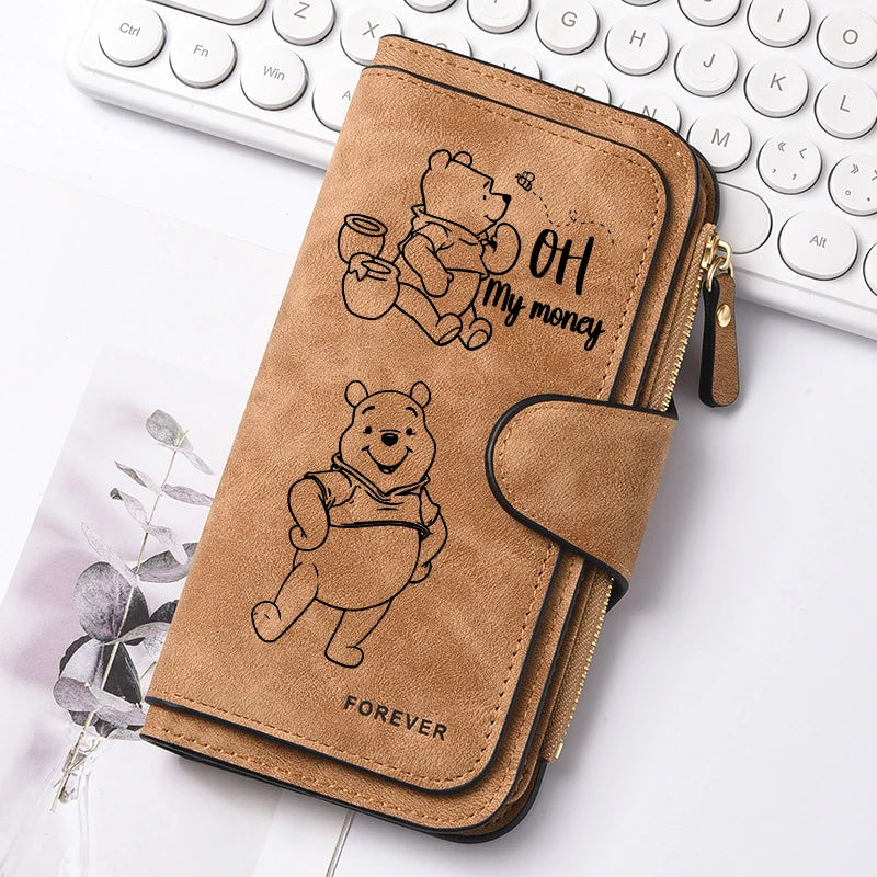 A brown leather zipper pouch featuring a bear illustration and the text OH my money FOREVER