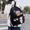 A woman is wearing a black Korean style large capacity backpack with padded compartments and a white sweater while walking on