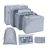 A set of gray fabric storage organizers including pouches and boxes for organizing various items.