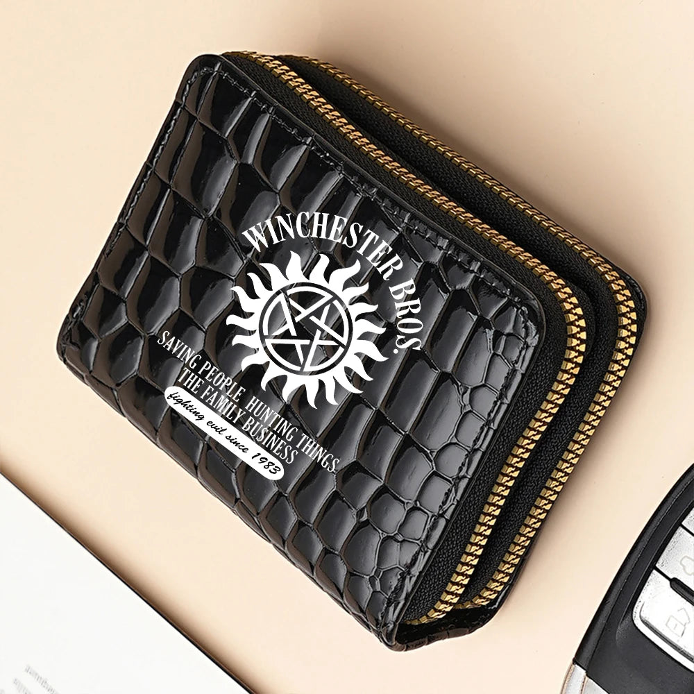 Black fashion PU leather double zipper wallet with gold stitching on a beige background.