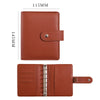 A brown leather ring binder notebook with a 115mm by 145mm size and a leather cover.
