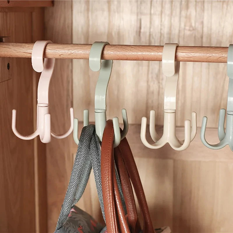 A wooden clothing rack with multiple multi-functional hanging hooks in pink, gray, and beige colors.