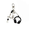 Silver music headphone keychain with a hook and chain attached to a black strap.