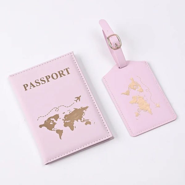 A pink leather passport holder and luggage tag set featuring a world map design.