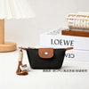 Black compact coin purse with a brown faux leather flap and braided keychain strap