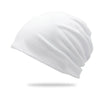 A white slouchy knit beanie hat shown from the side.