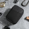 A black padded pouch for organizing multi-tools and outdoor gear placed on a gray surface.