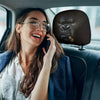 A woman in a car is talking on the phone while wearing silicone car headrest covers.